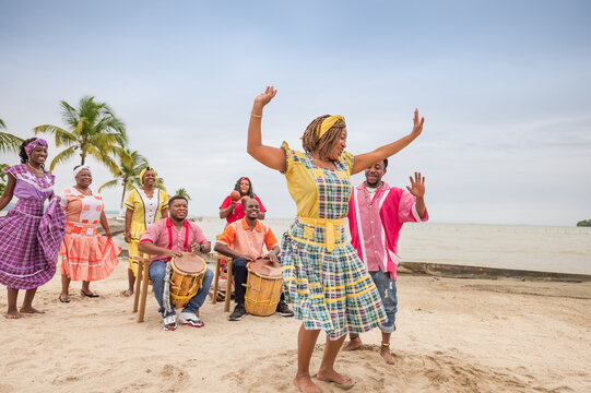 Beautiful Latina girl of the Garifuna ethnic group dances to the rhythm of the music.
