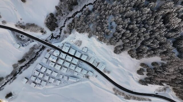 Aerial video above a small snowy village in winter in the Fontana val Bedretto Snow area
