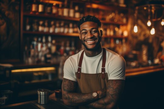 Smiling portrait of a young tattooed African American male bartender