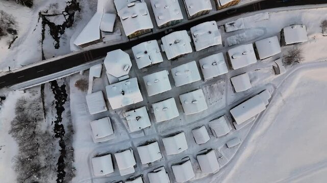 Aerial video above a small snowy village in winter in the Fontana val Bedretto Snow area