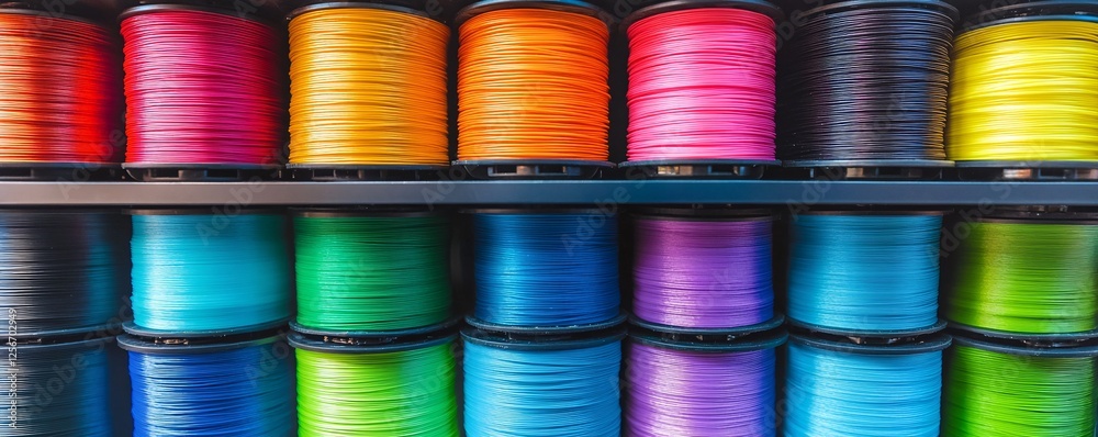 Poster Neatly arranged shelves display vibrant and organized rows of colorful thread spools, creating a pleasing visual