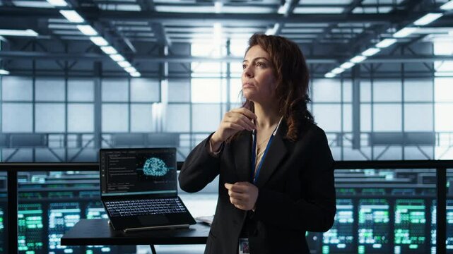 Technicians in high tech AI data center workspace looking at hologram visualization. Programmer working on securing server room hardware using AR artificial intelligence tech, camera B