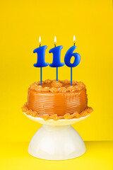 Happy birthday cake with number 116 candle - Card on a yellow background.