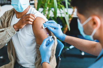 Vaccination, Immunization, Disease Prevention Concept. Closeup of African American man in face mask...