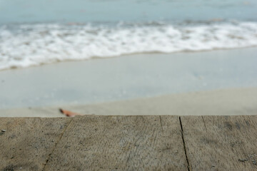 table top with blurred background of foam waves on the beach