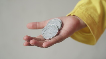 Indonesian coin money in girl's palm. Focus selected