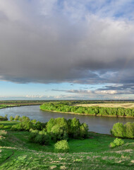 Fototapeta premium Cloudy sky with a river in the background