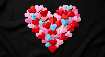 Happy Valentine's Day banner. Holiday background design with big heart made of pink, red and blue Origami Hearts on black fabric background. Horizontal poster, flyer, greeting card, header for website