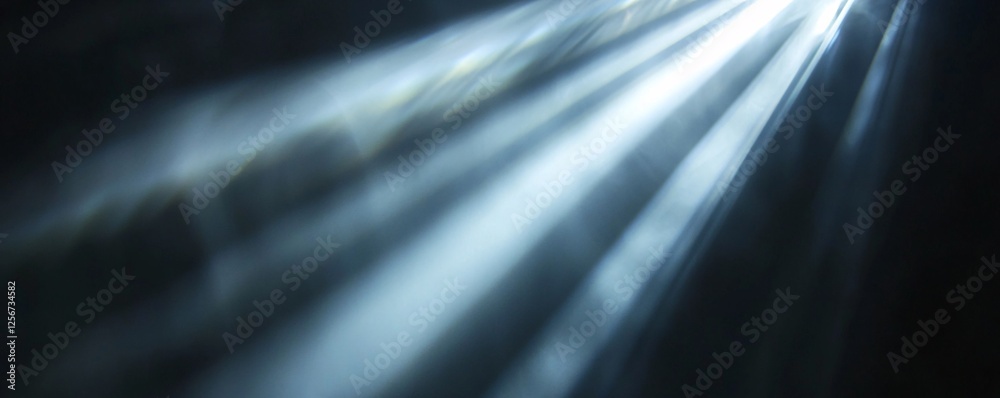 Poster abstract background featuring blurry blue and white light rays shining through darkness