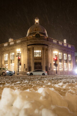 Car Driving Down the Street at Night in Georgetown Washington DC While it Snows