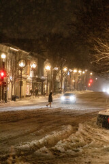 Person Crossing the Street at Night While it Snows in Georgetown Washington DC