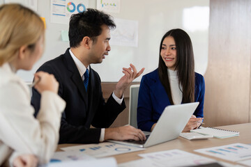 Business professionals presenting financial strategies in a modern office, engaging in collaborative discussions.