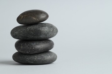 Stack of rocks on gray background, space for text. Harmony and life balance