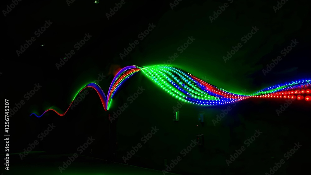 Poster dynamic display of multicolored led light waves forming vibrant patterns on a dark background, showc