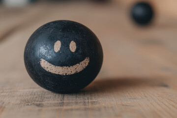 A black ball with a smiley face drawn on it