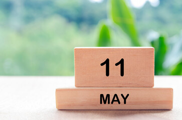 11 May text on wooden blocks with customizable space for text or messages. Month and copy space concept