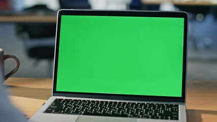 Student watching green screen laptop at modern apartment workplace closeup. - Powered by Adobe