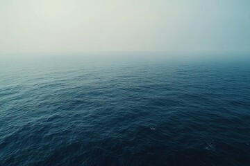 Obraz premium Tranquil open ocean under a misty sky Serene vast water ripples in the distance