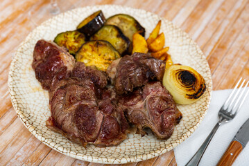 hearty lunch for restaurant guests includes piece of fried beef tenderloin with potatoes, zucchini, onions. Gastronomic tourism
