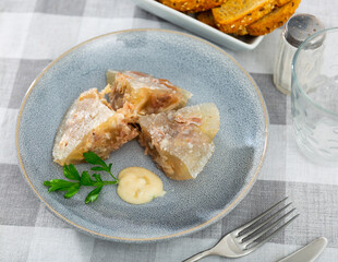 Traditional russian meat aspic dish kholodets on plate with mustard and parsley.