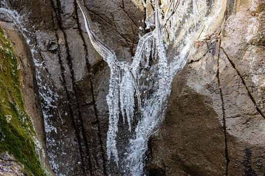Ice cycle cover small waterfall inside the zoo