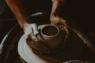 Person Working on a Clay Wheel, Shaping the Beginning of a Pot