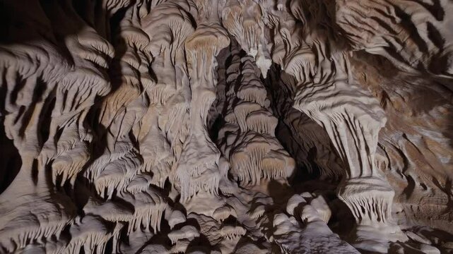 Stunning stalactite and stalagmite formations in limestone cave, captivating underground exploration concept