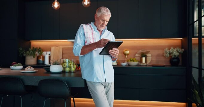 Senior man, home and tablet for meal prep, food website and online tutorial for culinary guide. Elderly person, retirement and thinking on nutrition in kitchen, ingredients plan and instructions
