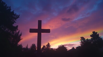 Majestic Cross at Sunset with a Rainbow: A Moment of Spiritual Reflection