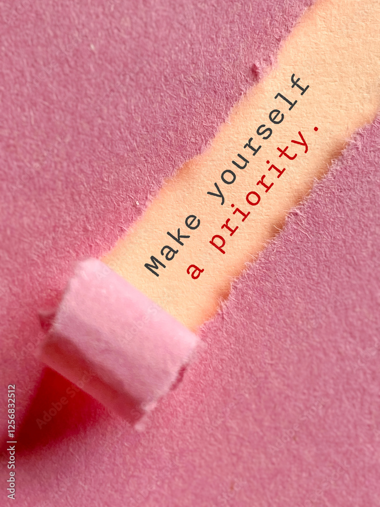 Fototapete inspirational quote. make yourself a priority text behind torn paper background.