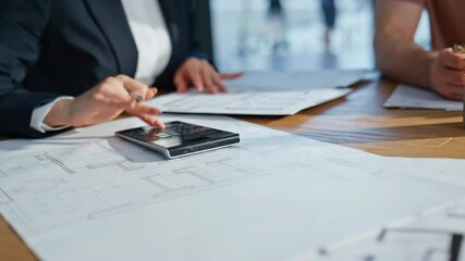 Businesswoman hands pressing calculator at work analyzing documents closeup.