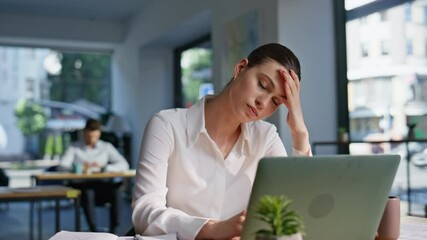 Worried professional solving issues at laptop workplace closeup. Tired woman