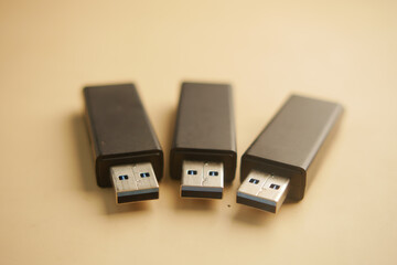 USB flash drives arranged neatly on a beige surface