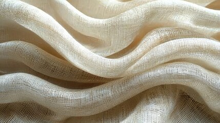 Close-up of soft, flowing beige fabric with gentle waves, creating a serene and elegant backdrop