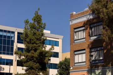 Fototapeta premium Afternoon sun shines on the historic buildings of the downtown skyline of Burbank, California, USA.