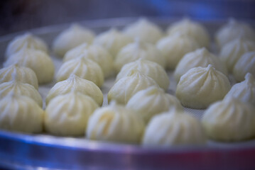 Close-up of steaming steamed buns and siomai in breakfast shop