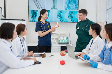 Fototapeta premium Male and female doctors are having a meeting in a hospital room.