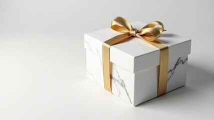 Obraz premium Elegant white marble gift box with a golden ribbon bow, perfect for special occasions and celebrations
