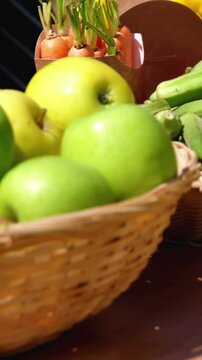 Close-up of harvested fruits and vegetable in wicker basket in field