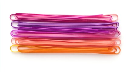 Colorful plastic paperclips, stacked, on white background. Possible use for office supplies