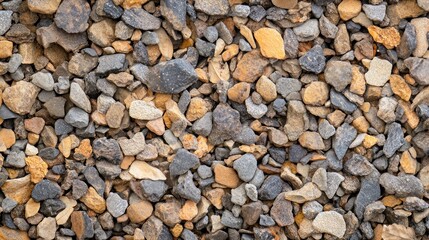 Close-up texture of mixed gravel stones in various colors and sizes.