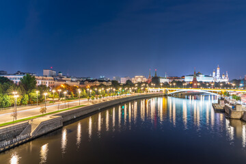 Illuminated Moscow Kremlin and Bolshoy Kamenny Bridge at summer night. View from the Patriarshy pedestrian Bridge