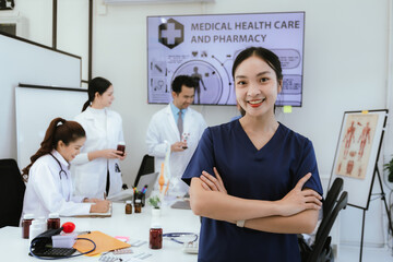 A diverse team of doctors and nurses work together in a hospital office and talk to each other. Teamwork and dedication to providing quality healthcare and medical solutions.