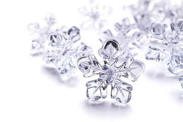 Clear plastic snowflakes against white background.  Possible use Holiday, winter, Christmas, education