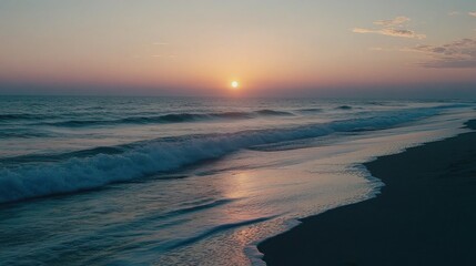 A beachside sunrise with pastel-colored skies reflecting on the gentle waves.