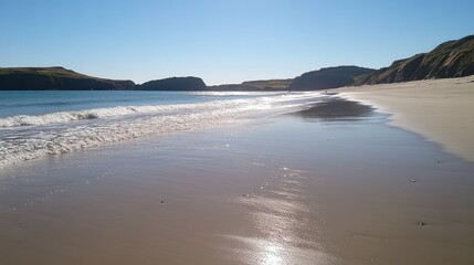 A gentle surf rolling onto a golden sandy beachside, sparkling under the midday sun.