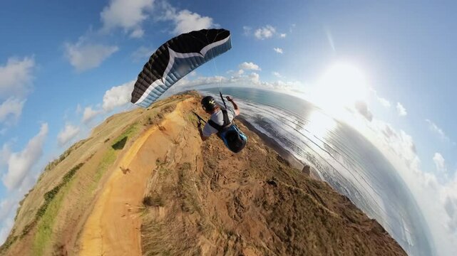 Paraglider soaring in New Zealand coast at sunset, adventure concept.