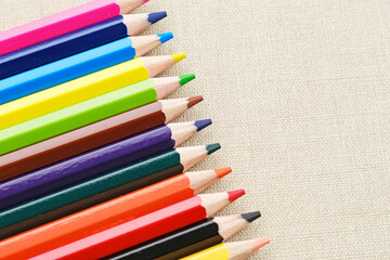 Colorful sharpened pencils are lined up on the table. Flat lay
