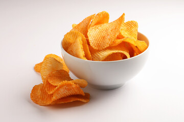 Spiced Crispy Potato Chips in white ceramic bowl on white background