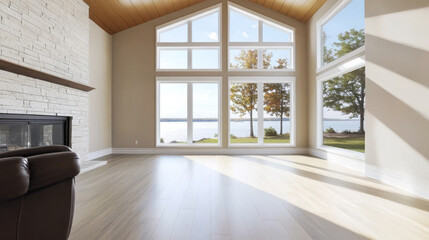Fototapeta premium Modern living room with large windows overlooking serene lake landscape in daylight